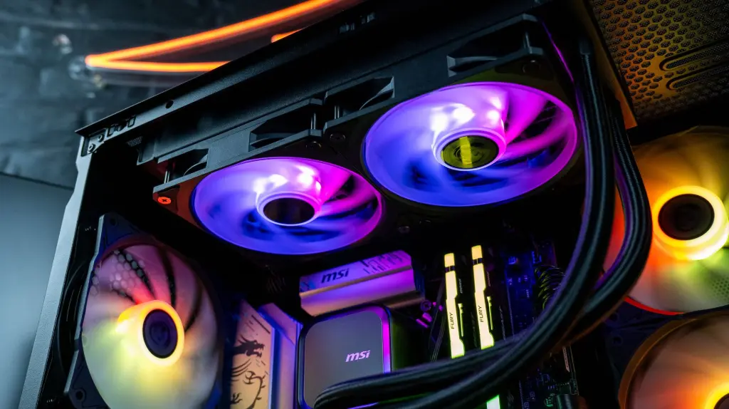 Intérieur d’un PC gamer RGB avec refroidissement liquide MSI, ventilateurs ARGB et barrettes RAM éclairées